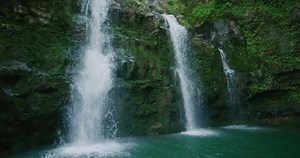 Amazing waterfall in the jungle, three waterfalls flowing in slow motion, jungle adventure vacation, natural power and beauty