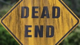 Dirty and old dead end road sign