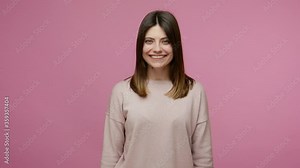 Hearing loss, deaf disability. Friendly girl communicating with deaf-mute sign language, making finger shape asking nonverbal phrase Hi, what time is it? indoor studio shot isolated on pink background