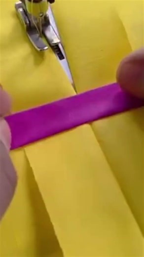 someone is sewing a piece of material