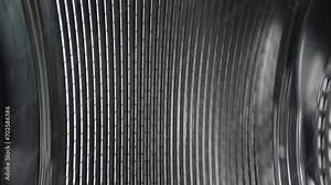Inside view of the washing machine drum, close-up of the stainless steel drum during the spin cycle. Metallic pattern.