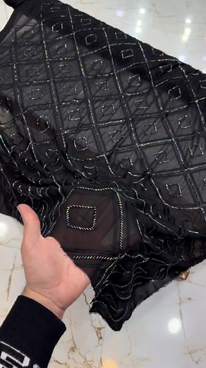 Intricate Black Fabric Design with Reflective Threads