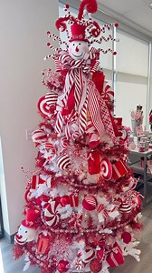 Feeling the peppermint craze this Christmas? This candy-coated tree is serving up sweet holiday vibes with stripes, swirls, and a jolly snowman topper! Would you decorate your tree like this? 🎄 🎄 #homedecor #wreath #crafting #diy #christmasdecor #christmasdecor #pepperminttree #peppermintchristmas #redandwhite #ornaments #christmas #merrychristmas #snowman #poinsettia #presents #treeinspo #christmasdecorations | The Wreath Shop