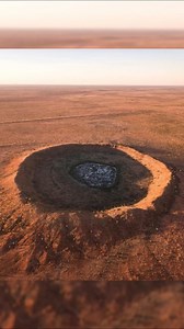 1.7M views · 27K reactions | Wolfe Creek Crater is situated on the edge of the Great Sandy Desert in northern Western Australia. It is the second-largest crater on Earth from which meteorite fragments have been recovered. It was likely formed by a meteor approximately 15 meters in diameter. The estimated age of the impact is around 120,000 years ago. | Unsolved Mysteries & Paranormal Activities | Facebook