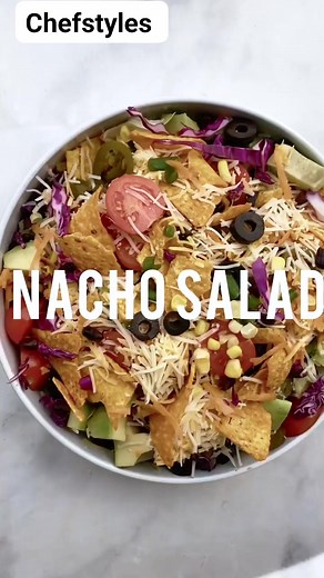 Nacho Salad Nachos Salad: 1 small head iceberg lettuce, chopped 1 large carrot, shredded 1 cup shredded purple cabbage (about 1/4 head) 1/2 cup sliced black olives 1/4 cup jalapenos 1/4 cup sliced cherry tomatoes 2 green onions, thinly sliced 1 avocado, cut into cubes 1 can corn kernels, drained 1 can black beans, drained 1/2-1 cup shredded Mexican or cheddar cheese 1 cup nacho chips like Doritos Dressing: 250 g Sour cream (1 cup or 1 container) 2 tbsp mayonnaise 2 limes, squeezed 2 tbsp olive o