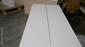 A stack of MDF panels close-up at a furniture production facility. Furniture production, blanks close-up. MDF panels for furniture production, close-up.