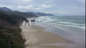 Pacific Ocean waves wash against an empty beach in Oregon, not far west of Portland. The scenic U.S. Route 101 runs right along this beautiful part of the west coast.