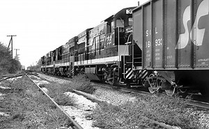 Seaboard Coast Line GE U18B diesel electric locomotives lead a northbound freight train along the mainline and out of Lakeland, Florida, 1970's - 3