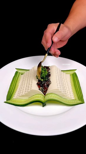 Arts Promote 🎨 on Instagram: "In the world of culinary art, one exceptional creator elevates food presentation to an entirely new level. This artist skillfully transforms simple ingredients like cheese and vegetables into breathtaking works of art. In a recent piece, they intricately sliced and arranged these elements to resemble a captivating book and a delicate butterfly. Each component is placed with astounding precision, showcasing the artist's extraordinary talent and creativity. The fine