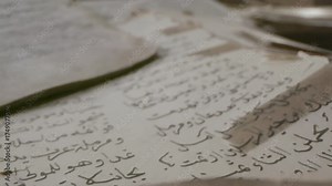 Explore detailed pages of old manuscripts filled with Arabic text in a quiet library. Each sheet reveals history and mystery from the past.