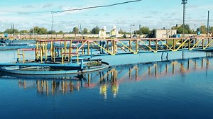 Two wastewater operators monitoring a sewage treatment plant