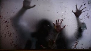 Blurry zombie hands claw at blood-splattered window. Eerie presence of zombies, haunting visual. Desperate zombie scratches, chilling spectacle, provoking horror and fear of zombies Apocalypse concept