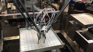 An AI-powered robotic packaging machine is demonstrating its functionality in public view.
