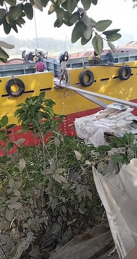 Grain Unloading Process on Rustic Fishing Boat