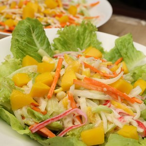 how to make Kani salad with mango and lettuce recipe. kani Salad with mango and lettuce is a Japanese crab salad made from imitation crab sticks. To have the best kani salad try to choose fresh Mangoes and lettuce. Cooking the crab sticks is also optional or you can just put hot water. #mangokanSalad #Kanisalad #Kanisaladrecipe | FriendCheap Menu
