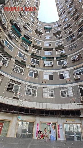 A uniquely designed building in Wuhan, central China's Hubei Province, forms a "keyhole" in the sky when looking up from the center of its arch. | People's Daily, China