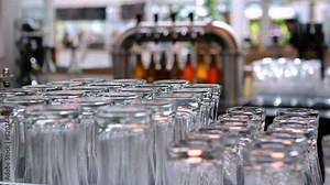 Close-up perfectly washed and polished beer glasses. Glasses turned upside down sit on bar counter, demonstrating impeccable cleanliness and order of pub. Glasses symbol of impeccable service in bar.