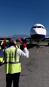 ✈️🚧 Marshalling is one-on-one visual communication and a part of aircraft ground handling. At airports, the marshaller signals the pilot to keep turning, slow down, stop, and shut down engines, leading the aircraft to its parking stand or to the runway. #airport #aircraft #plane #planespotting #tia #tirana | Tirana International Airport