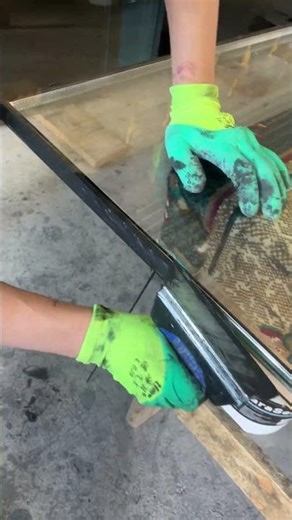 Applying silicone to a double glazed window.