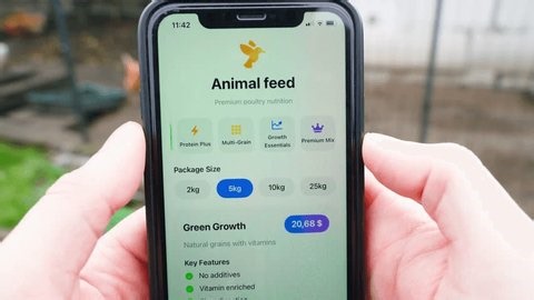 clip-3965699663-farmer-buying-chicken-feed-through-mobile-app