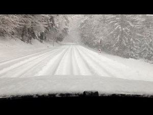 BMW X6 xDrive40d Driving up a Mountain Road in Deep Snow