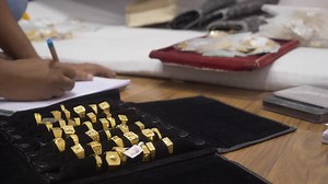 A shopkeeper making counts of hallmarked designer gold jewelry, wedding rings | Premium Stock Video Footage