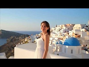 Beautiful Woman in Flowing White Dress on a Terrace in Oia, Santorini, Greece #Woman #Santorini