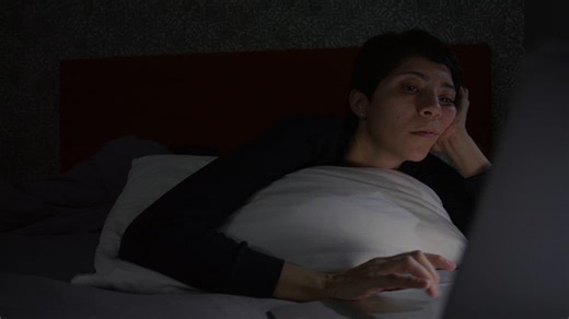 Girl with insomnia in her computer in her bed - Free Stock Video