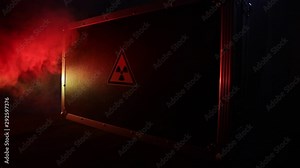Radioactive (atomic ionizing radiation) danger warning symbol in triangular on a black case. Black suitcase with a sign of radiation hazard. Dark background.