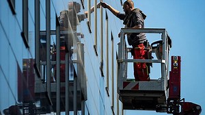 Window cleaner pets cute dog mid-air