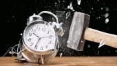 Slow motion medium locked down shot of a ringing two bell alarm clock...