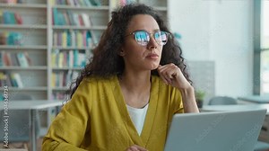 Latina Caucasian Hispanic woman working typing laptop desktop computer pc library university research project educate technology e-learning student diploma contemplation aspirations girl female study