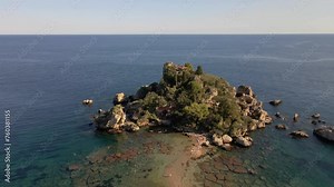Isola Bella Beach Taormina Sicily Island Italy, is a beautiful bay in summer with a blue ocean, Aerial view of the island and Isola Bella Beach and blue ocean water in Taormina, drone view