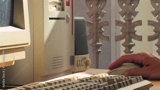 Man working and gaming on retro computer PC, IT engineer with vintage computer at home, using old fashion technology, close up of retro setup.