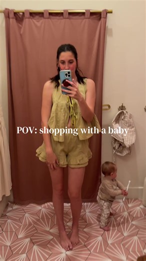 Mom Tries on Clothes While Shopping with Baby