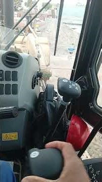 Operating a Caterpillar backhoe.