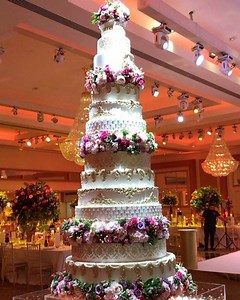 2.9K views · 112 reactions | Asian wedding cakes creating the biggest and tallest cakes in the UK. Our 12 tier cake with flower separators created for TAsnim & Sami. The biggest cake is a whopping 34inch. | Asian Wedding Cakes | Facebook