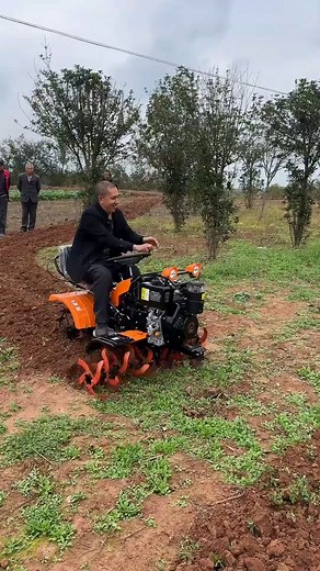 Discover a compact ride-on rotary tiller designed for efficient gardening. Rotating tines loosen soil into even strips, a seated control layout supports steady passes along rows, and built-in lights help with visibility at the plot edge. | Party Access