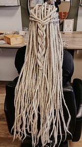 First time dread extensions for Renee! She has had a lot of different hairstyles but never dreads. Time to check that off the list! ☑️ She wanted a natural set matching her own hair color so she picked the Original Locks of Love in Honey Blonde, bum length. Suzanne installed them and right away Renee totally rocked this amazing look! You can see from her smile how much she loves them. 🤎 She wanted to keep her bangs loose so Suzanne also cut them for her to perfectly frame her face. Now that’s a