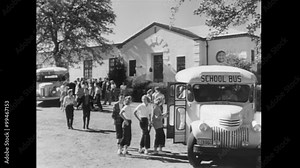 Wide shot of students boarding school bus, 1940s