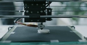 clip-1082403523-3d-printer-working-producing-rapid-prototype-close