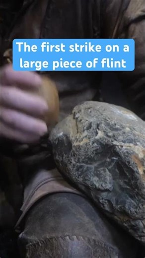 The first strike on a large piece of flint, using a quartzite pebble hammer stone