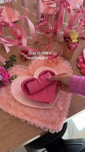 heart napkins! 💕 a cute way to fold napkins for your next galentines get together with the girls! Fold into a triangle Bring ends in making an “envelope” Fold both edges in and flip over Roll turn Bring back edges in Shape the heart #galenntine #galentinesparty #tablescape #tablescapeinspo #valentine #pinkaesthetic #bowtrend #diyparty #diy #partydecor #heartnapkinfold