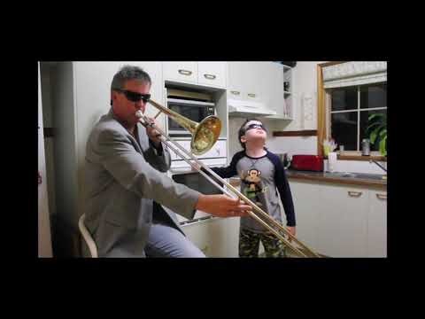 Dad and son playing with a trombone and oven during Timmy Trumpet 🎺.