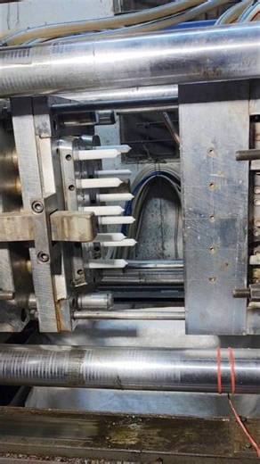 A man is skillfully making plastic bottles using a machine.