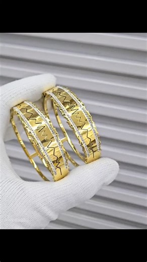 Hi gorgeous women range on Instagram: "​✨ The Collection Highlight: ​The Minimalist: Elegant gold-toned knot cuffs for effortless chic. 🎗️ ​The Glamour: Bold, wide bands featuring intricate pavé crystals and geometric centers. 💎 ​The Romantic: Delicate floral cut-outs and heart accents. 🌸 ​The Icon: Striking black clover motifs on textured gold bands. 🍀 ​The Modernist: Sleek "heartbeat" zig-zag patterns and coin-edge finishes. ⚡ ​💎 Luxury in every detail. ✨ Designed to be stacked or worn so