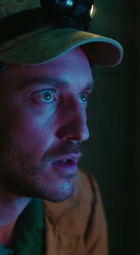 An archaeologist's flashlight illuminating ancient hieroglyphics that suddenly start glowing