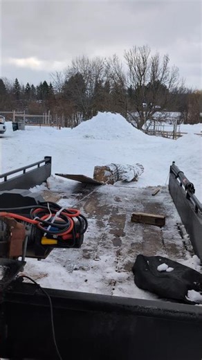 using winch to move heavy log onto trailer