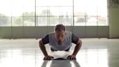 Young adult man doing push ups exercise during fitness sport workout...