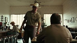 I remember remarking on Tommy's huge hands as we filmed this scene. I have big hands and his fists resting on the table dwarfed my own. "Jesus, Tommy. Do a little boxing in your day?" "Never hit anybody in my life," he said, surveying his flattened knuckles. "Just work, I guess. Work and football." | Garret Dillahunt